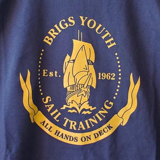 Blue t-shirt with a logo on a hanger in front of a bookshelf